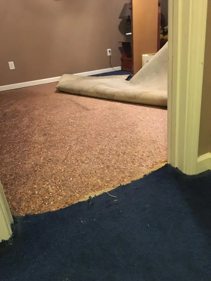 Carpet pad removal revealing water damage during Water Mitigation Services in Buena Park